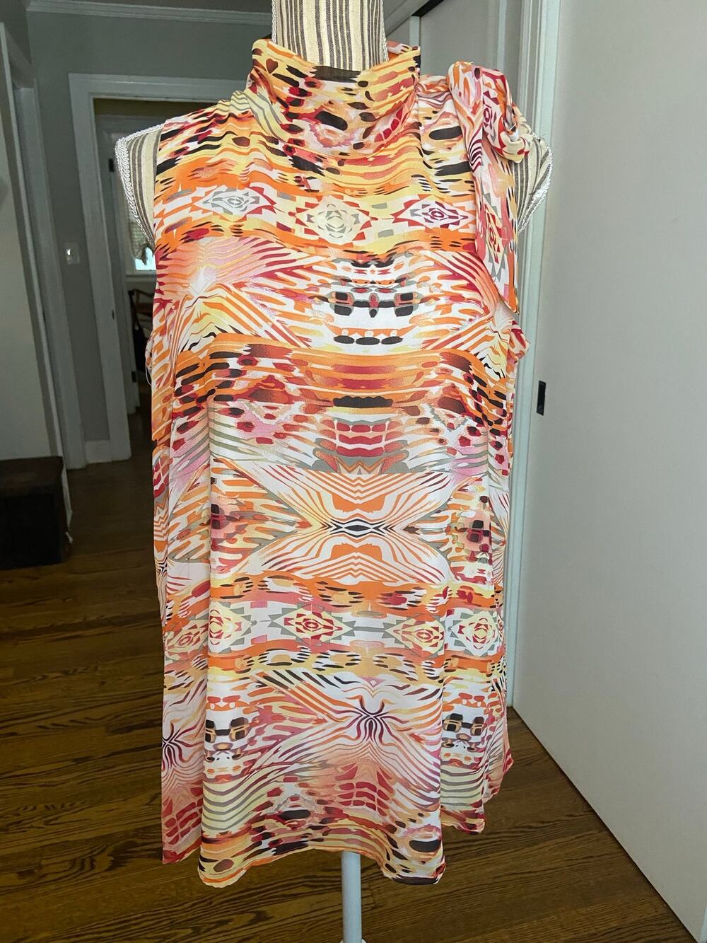 Coral multi print sleeveless chiffon mock neck blouse w/ tie detail at shoulder